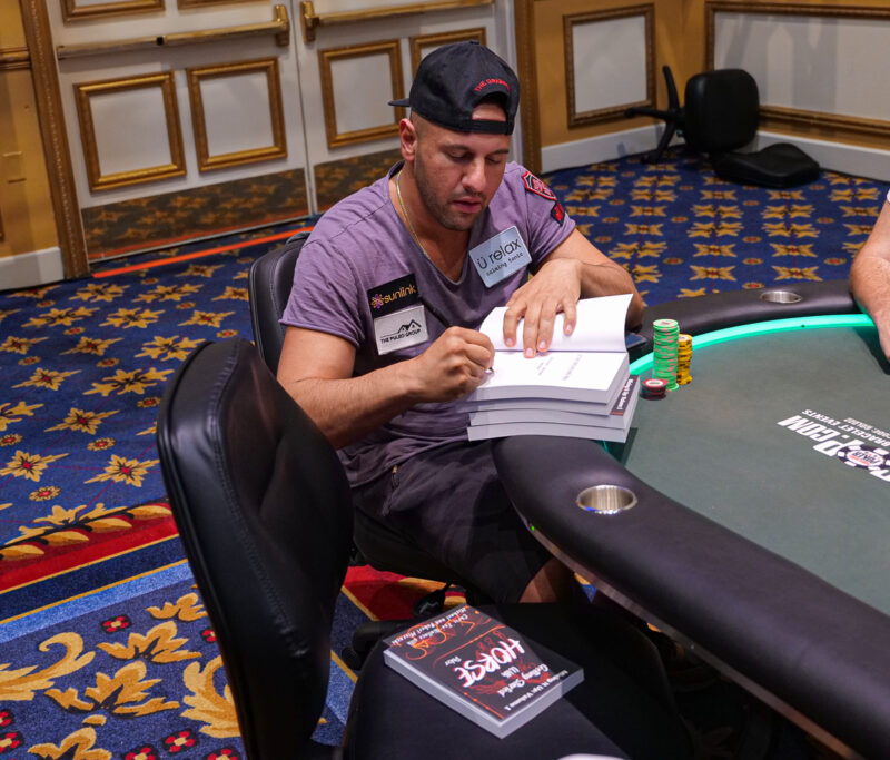 Michael Mizrachi signing books