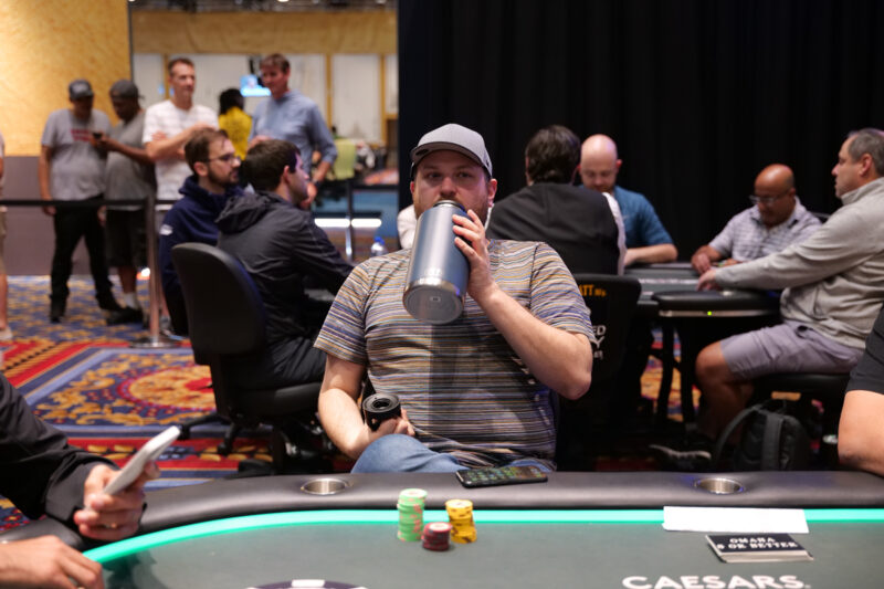 scott seiver drinks water at a poker table