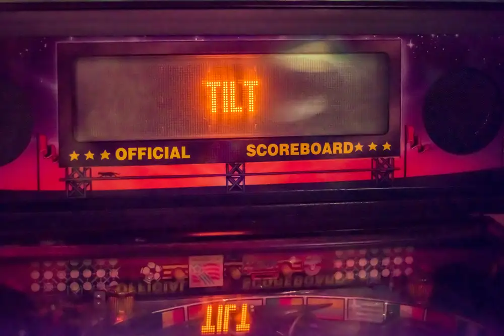 A pinball table showing a tilt symbol on its graphical scoreboard display.