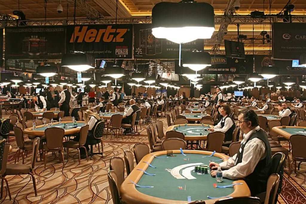Dealers at empty poker tables await players for the WSOP
